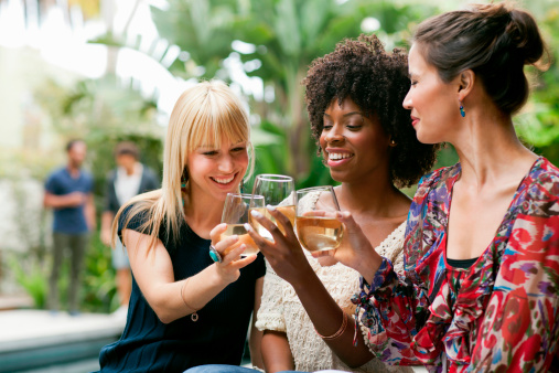 Female friends toasting with wine